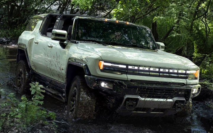 GMC Hummer driving within a forest