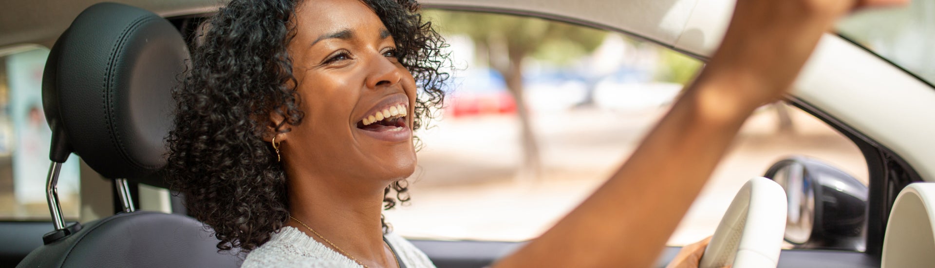 Woman checking rear view mirror before driving off
